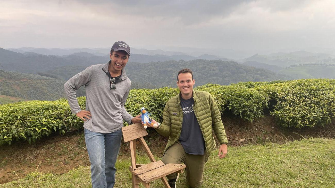 Two students with Cecil in front of mountains